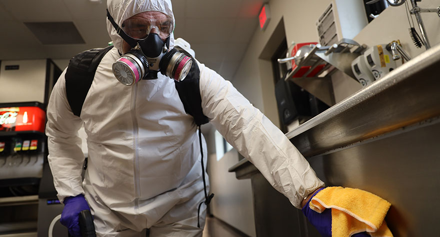 Wiping Industrial Sink with Sanitizing Wipe