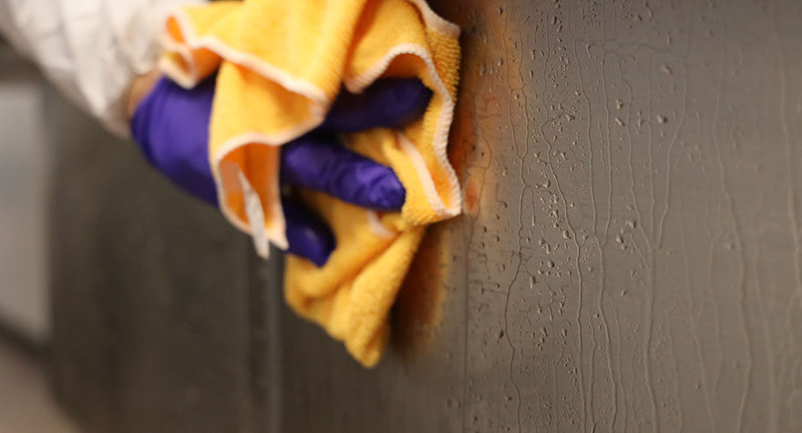 Wiping Industrial Sink with Sanitizing Wipe
