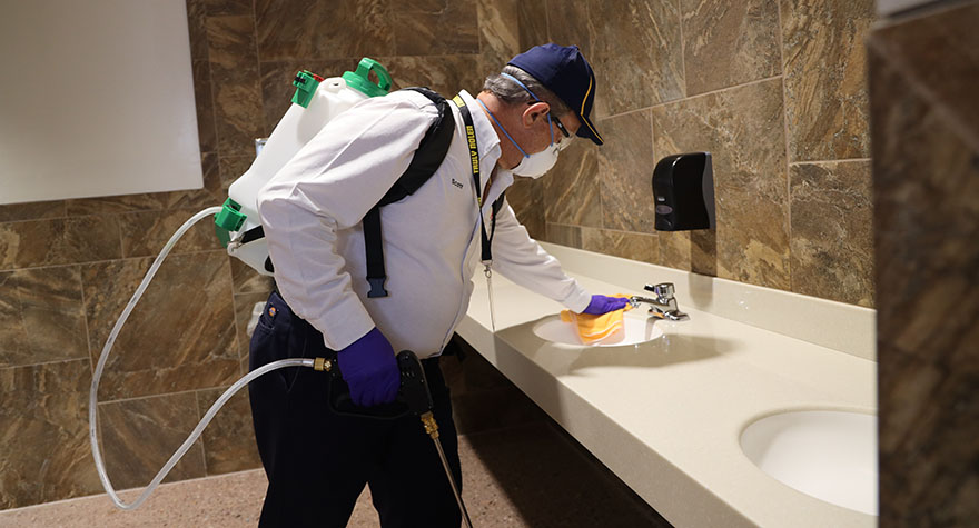 Wiping Bathroom Sink Counter with Sanitizing Wipe