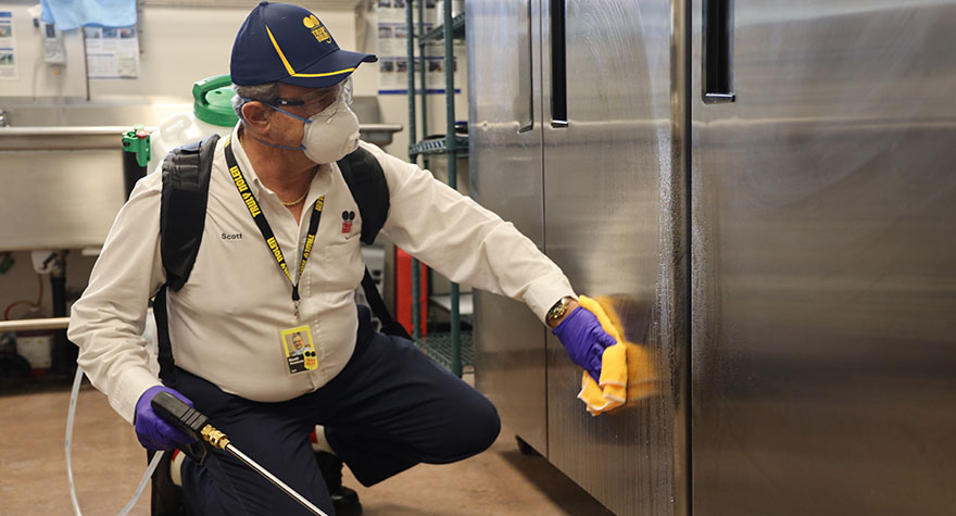 Wiping Industrial Refrigerator with Sanitizing Wipe