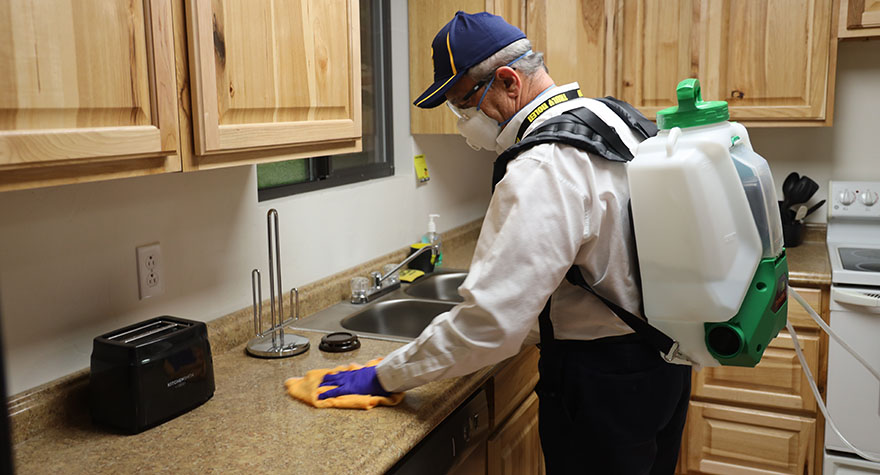 Wiping Kitchen Counter with Sanitizing Wipe