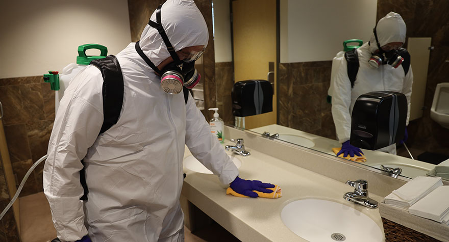 Wiping Bathroom Sink Counter with Sanitizing Wipe